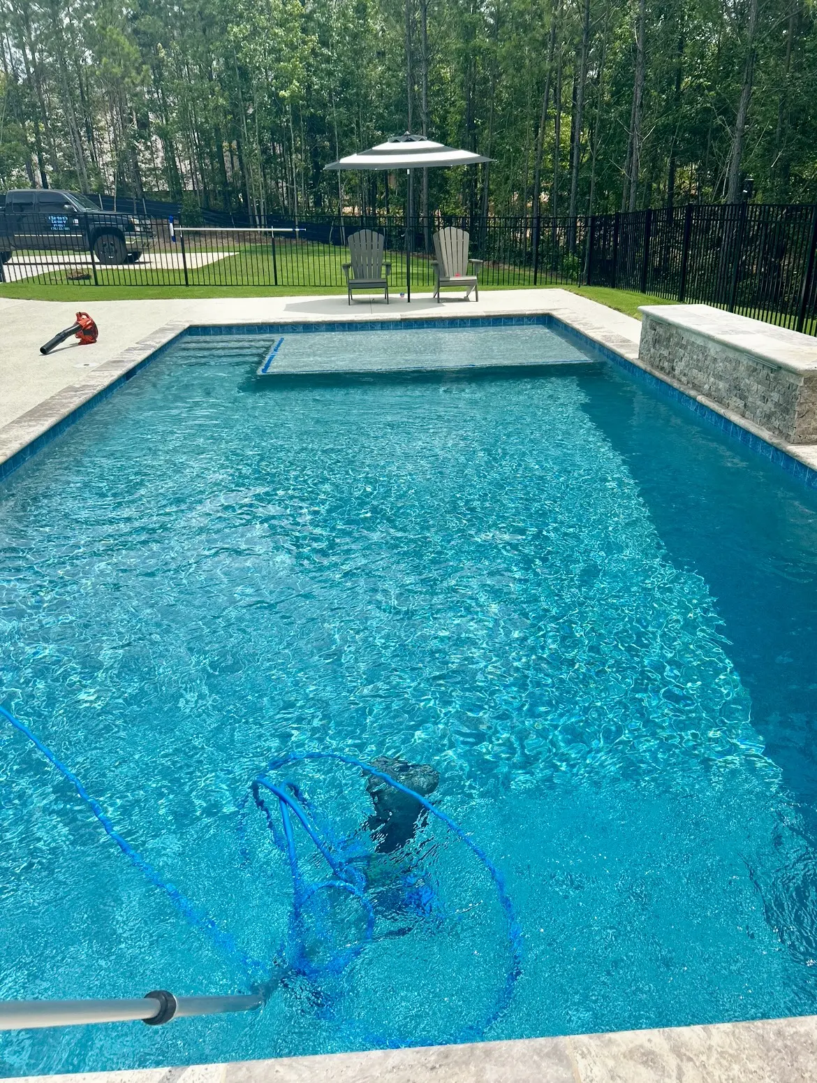 Pool vacuuming in progress during a service visit